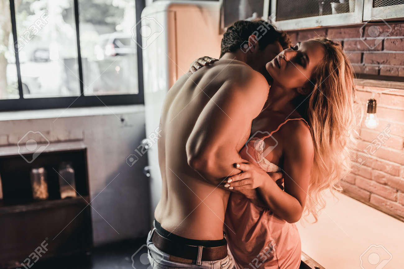 Attractive Passionate Couple Is Having Sex On Kitchen. Фотография,  картинки, изображения и сток-фотография без роялти. Image 83407391
