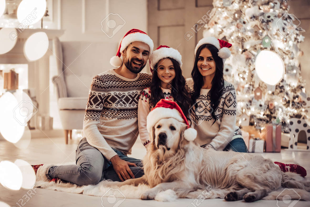 Merry Christmas and Happy New Year! Happy family with dog labrador..