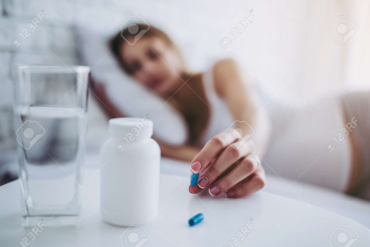 Attractive Sick Pregnant Woman Is Lying In Bed Taking Pills Stock Photo Picture And Royalty Free Image Image 92680178