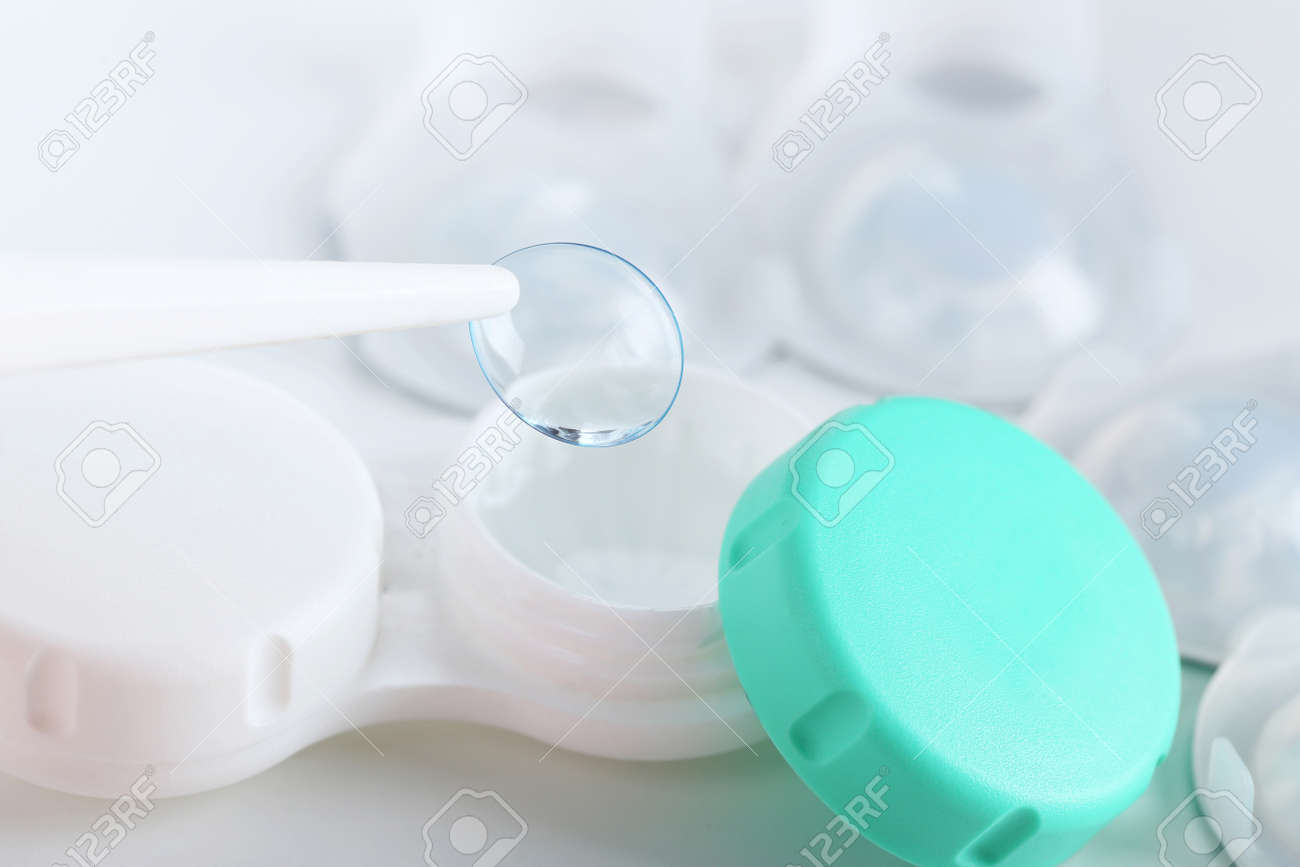 Contact lenses holding by tweezers, close up - 49304040 Contact lenses holding by tweezers, close up - 49304040