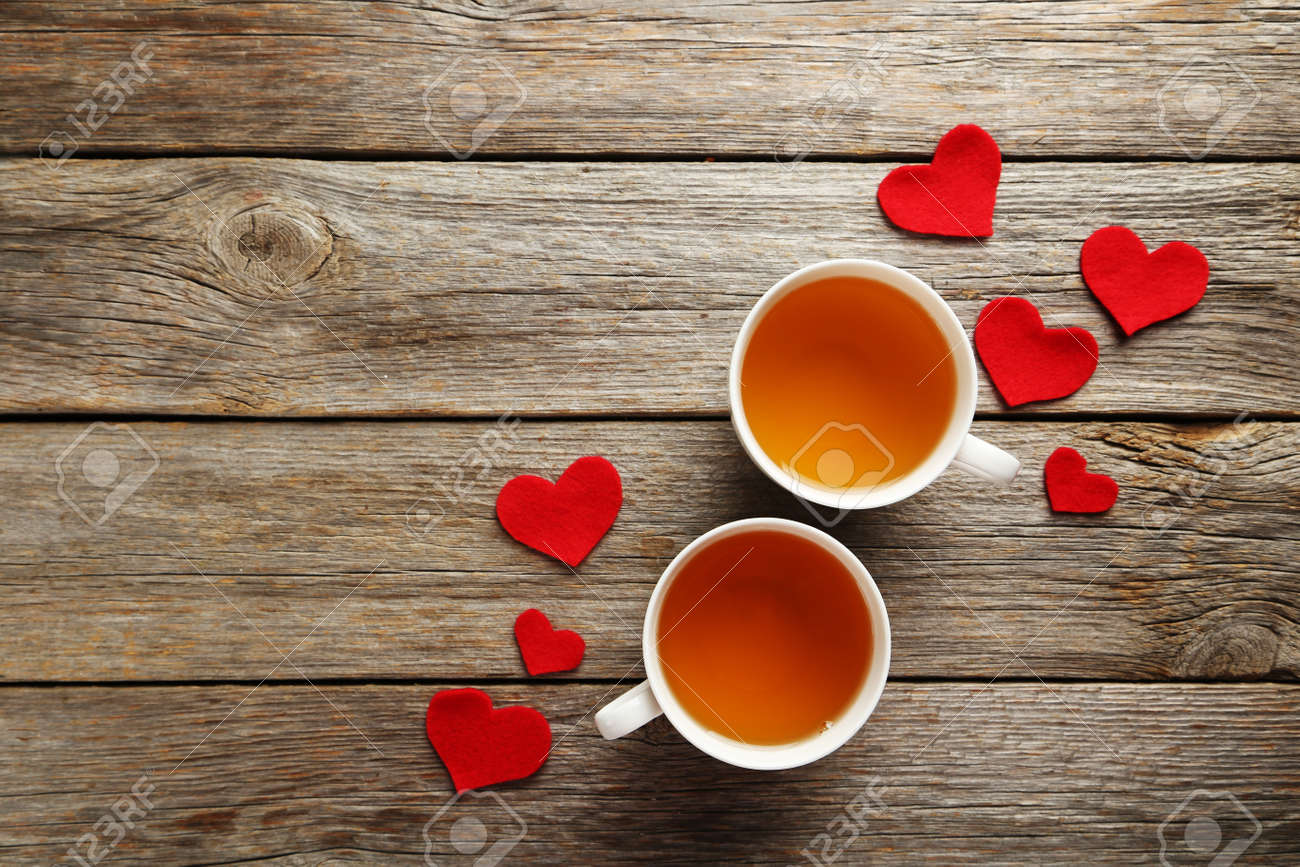 Love hearts with cups of tea on a grey wooden table - 50736659 Love hearts with cups of tea on a grey wooden table - 50736659