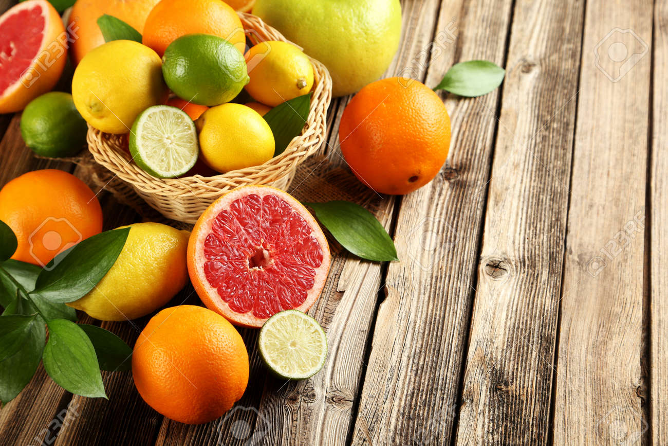 Citrus fruits on a brown wooden table - 51481350 Citrus fruits on a brown wooden table - 51481350