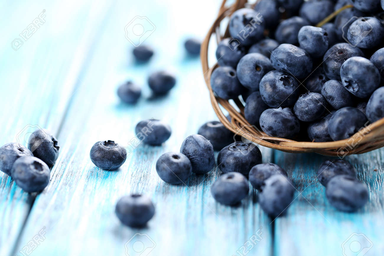 Tasty blueberries in basket on a blue wooden table - 51612251 Tasty blueberries in basket on a blue wooden table - 51612251