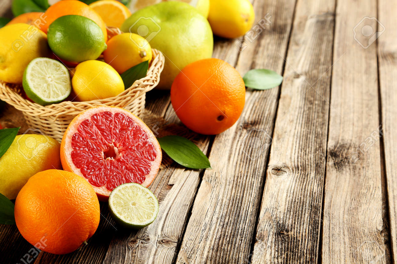 Citrus fruits on a brown wooden table - 52852529 Citrus fruits on a brown wooden table - 52852529