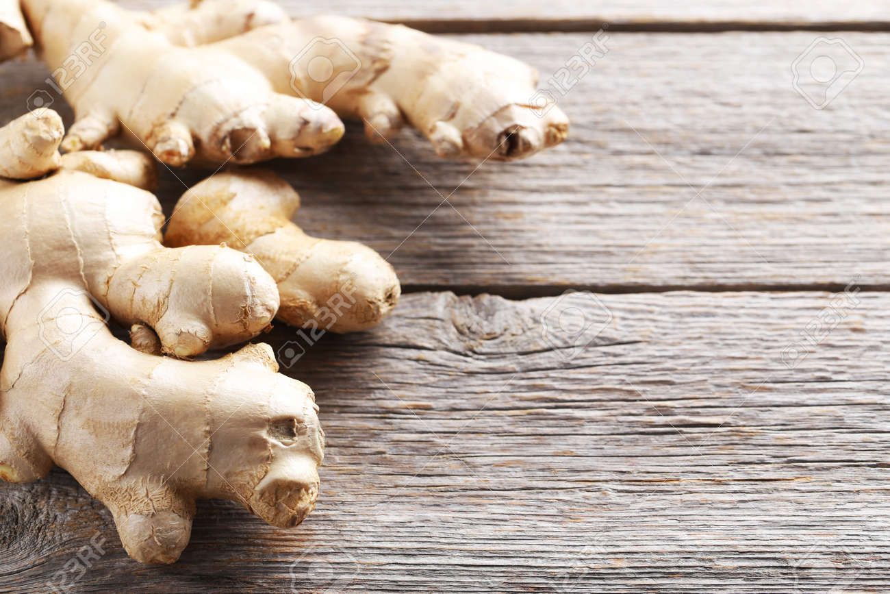 Ginger root on grey wooden table - 69026691 Ginger root on grey wooden table - 69026691