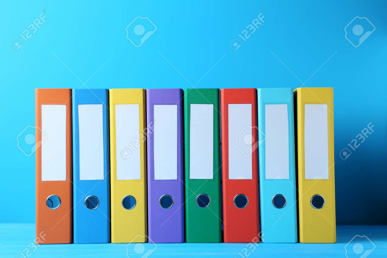 Colorful office folders on blue background - 80986196 Colorful office folders on blue background - 80986196