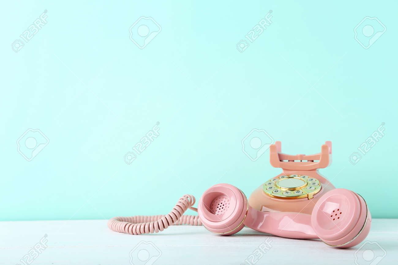 Pink retro telephone on white wooden table - 87516083 Pink retro telephone on white wooden table - 87516083