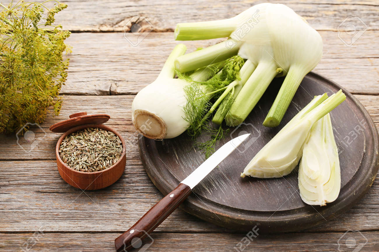 Ripe fennel bulbs and dry seeds in bowl on grey wooden table - 96380946 Ripe fennel bulbs and dry seeds in bowl on grey wooden table - 96380946