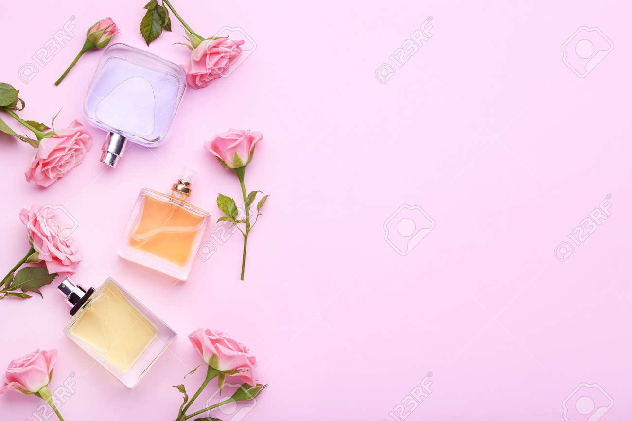 Perfume bottles with flowers on pink background - 97392381 Perfume bottles with flowers on pink background - 97392381
