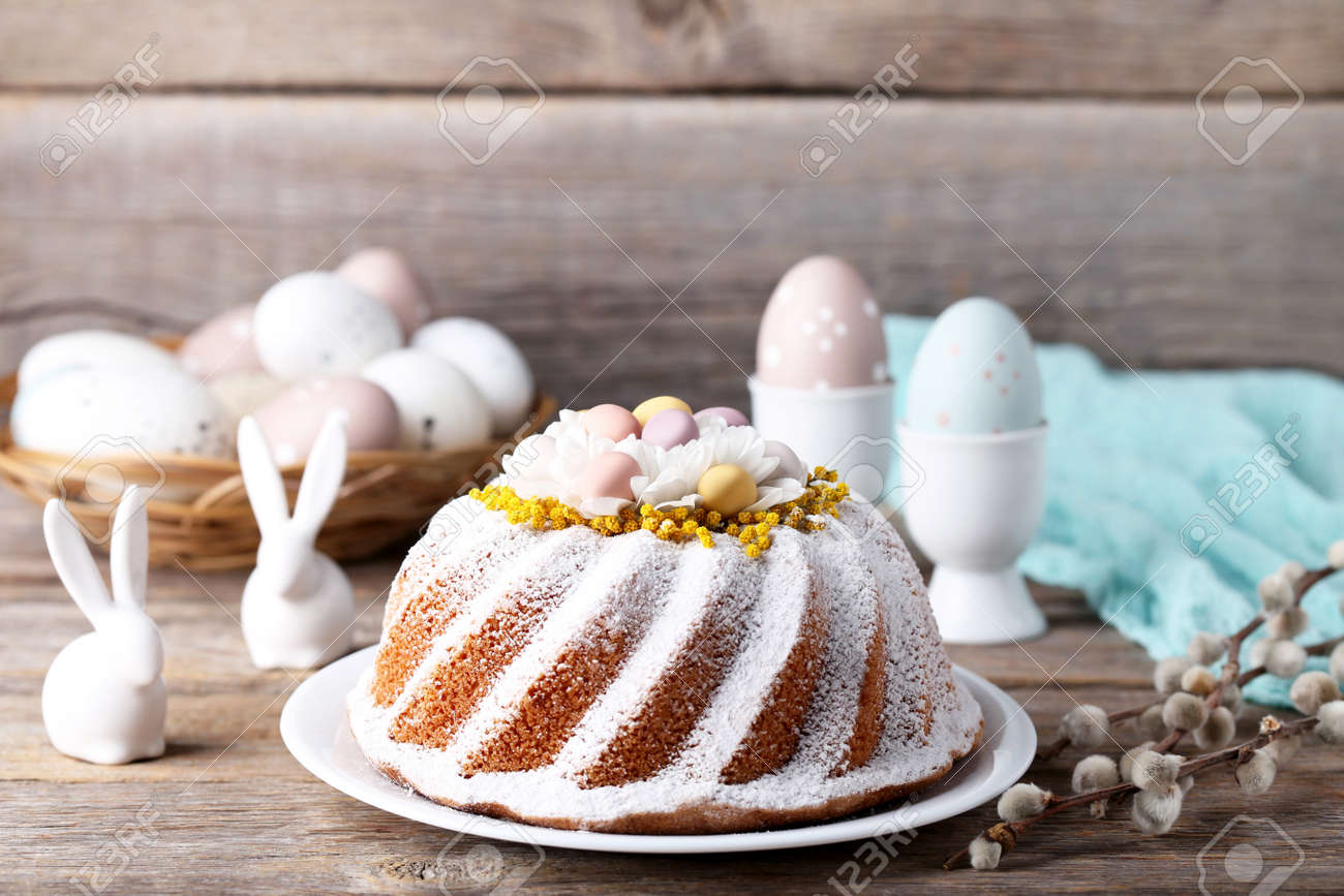 Easter cake with eggs and ceramic rabbits on grey wooden table - 97740643 Easter cake with eggs and ceramic rabbits on grey wooden table - 97740643
