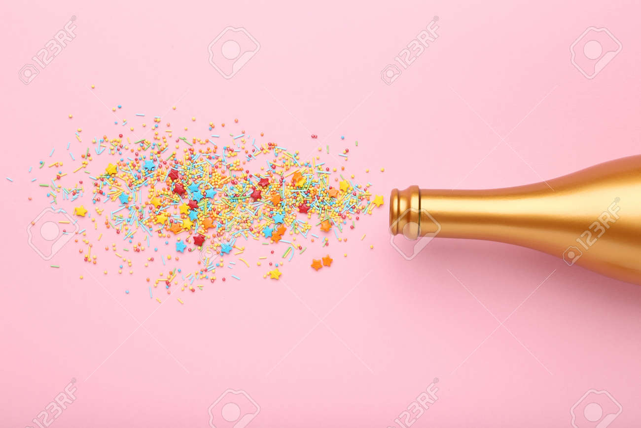 Champagne Bottle With Colorful Sprinkles On Pink Background Stock Photo,  Picture and Royalty Free Image. Image 110058620., image size:1300x867