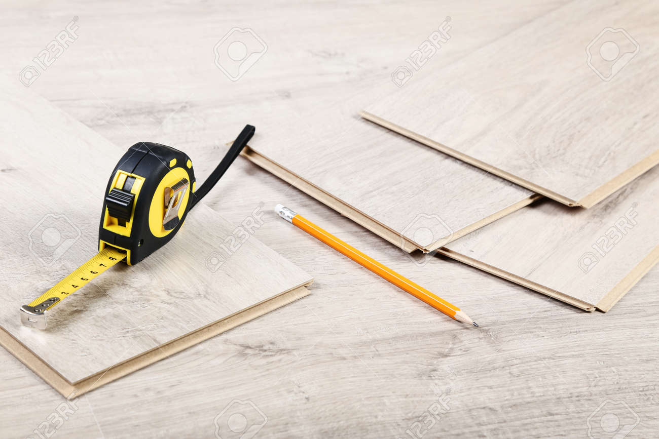 Timber laminate flooring with pencil and measuring tape - 118016388 Timber laminate flooring with pencil and measuring tape - 118016388