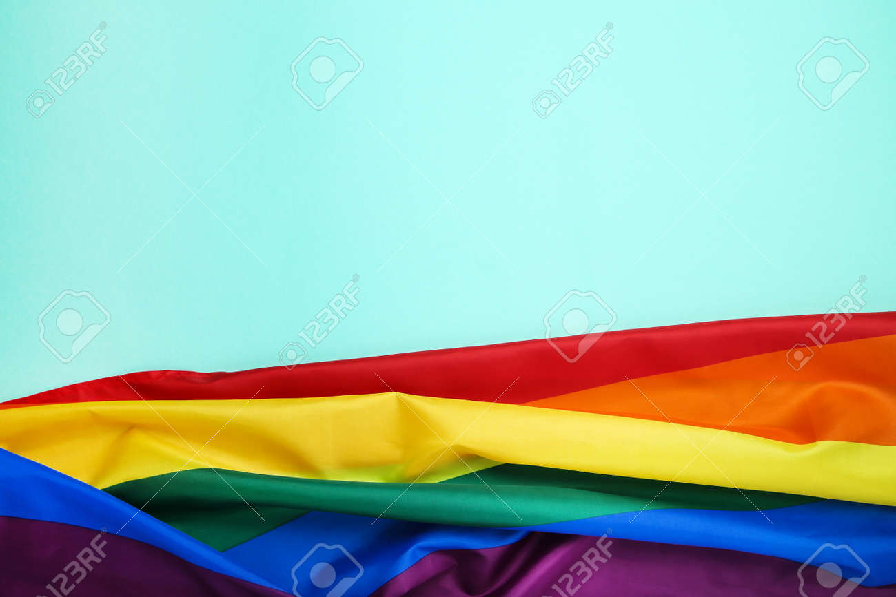 Rainbow flag on blue background - 122998954 Rainbow flag on blue background - 122998954