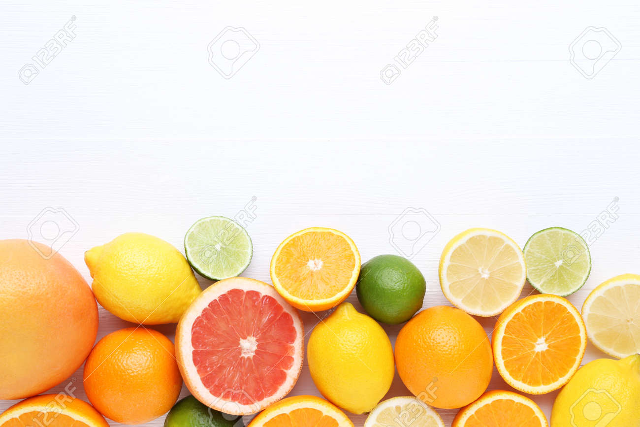 Citrus fruits on white wooden table - 128885049 Citrus fruits on white wooden table - 128885049