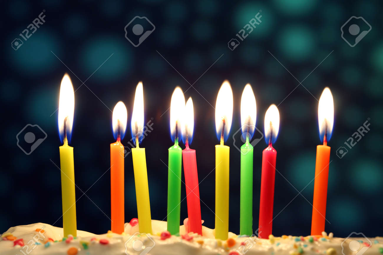 nine lit birthday candles close up shallow dof stock photo picture