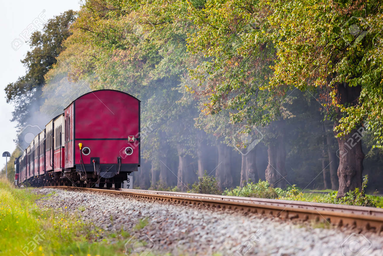 Back Of A Steam Train With A Red Rail Car At The End On A Track ...