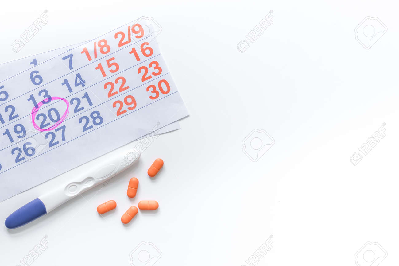 pregnancy planning pregnancy test calendar and pills on white calendar pregnacy