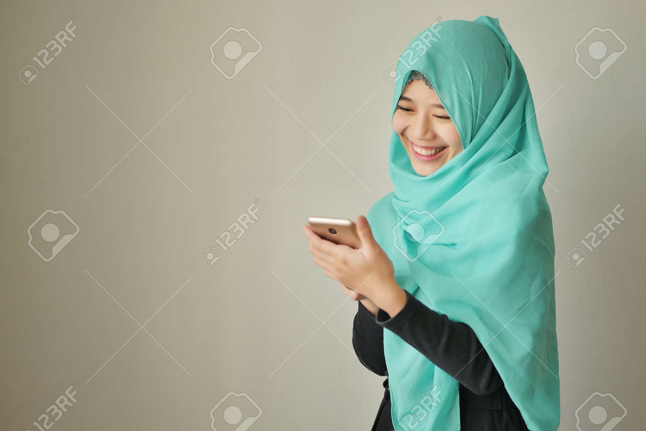 happy exotic woman using smart phone - 93050115 happy exotic woman using smart phone - 93050115