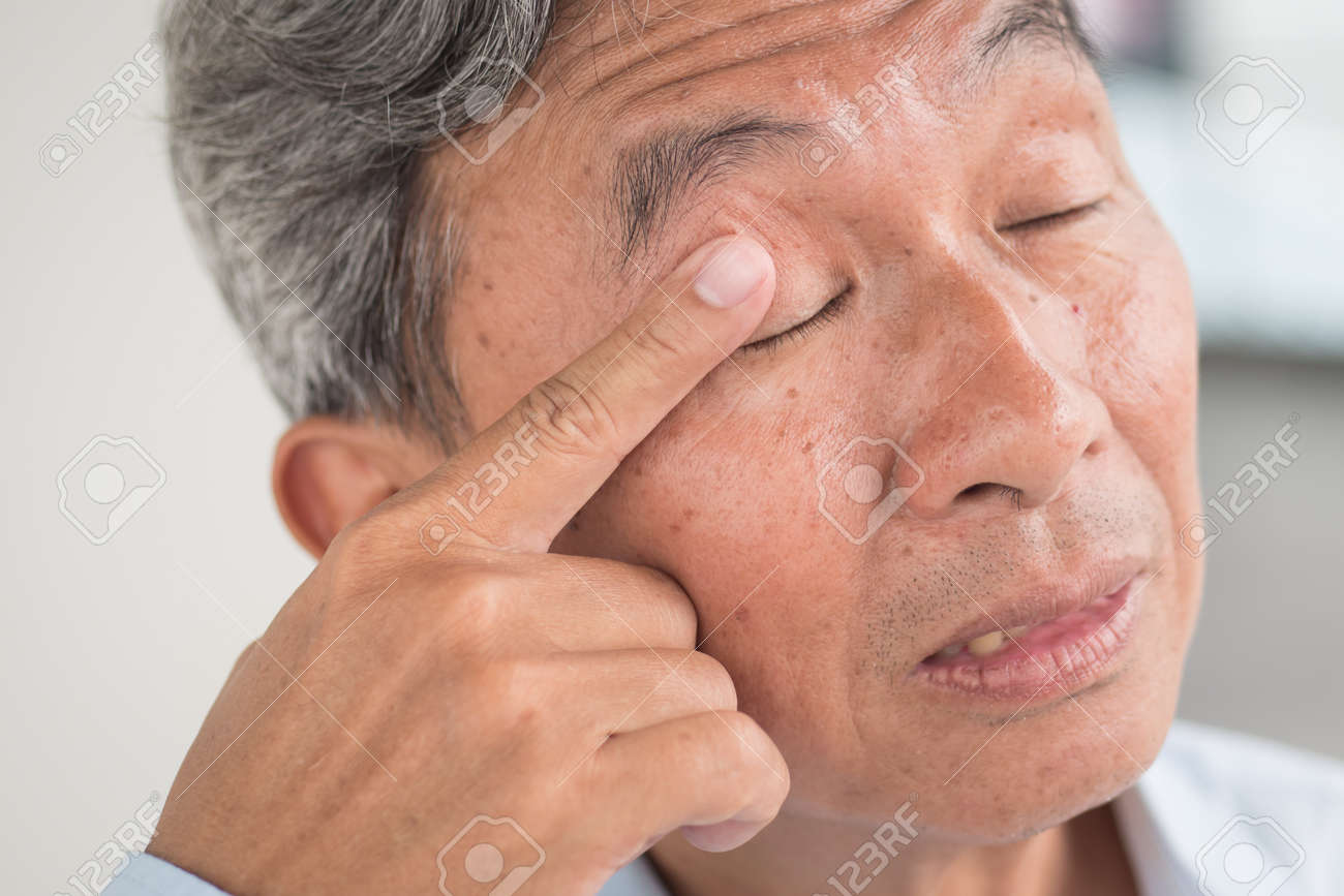 old man with eye irritation optical problem stock photo picture