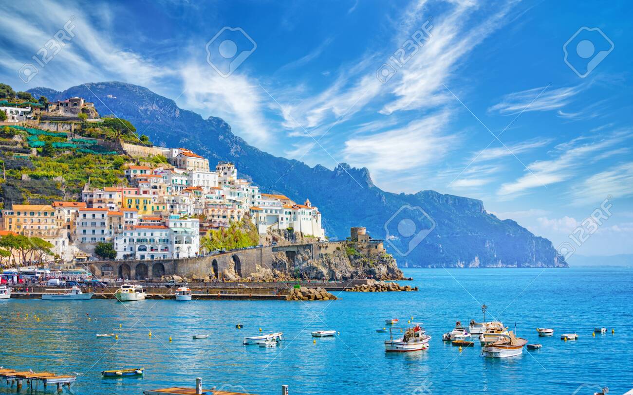 Beautiful Amalfi on hills leading down to coast, comfortable beaches and azure sea in Campania, Italy. Amalfi is most popular travel and holyday destination in Europe. - 126889071 Beautiful Amalfi on hills leading down to coast, comfortable beaches and azure sea in Campania, Italy. Amalfi is most popular travel and holyday destination in Europe. - 126889071