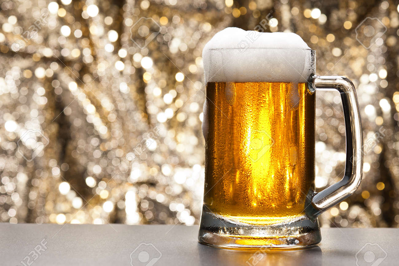 beer mug in front of a glittering background with a cool beer stock