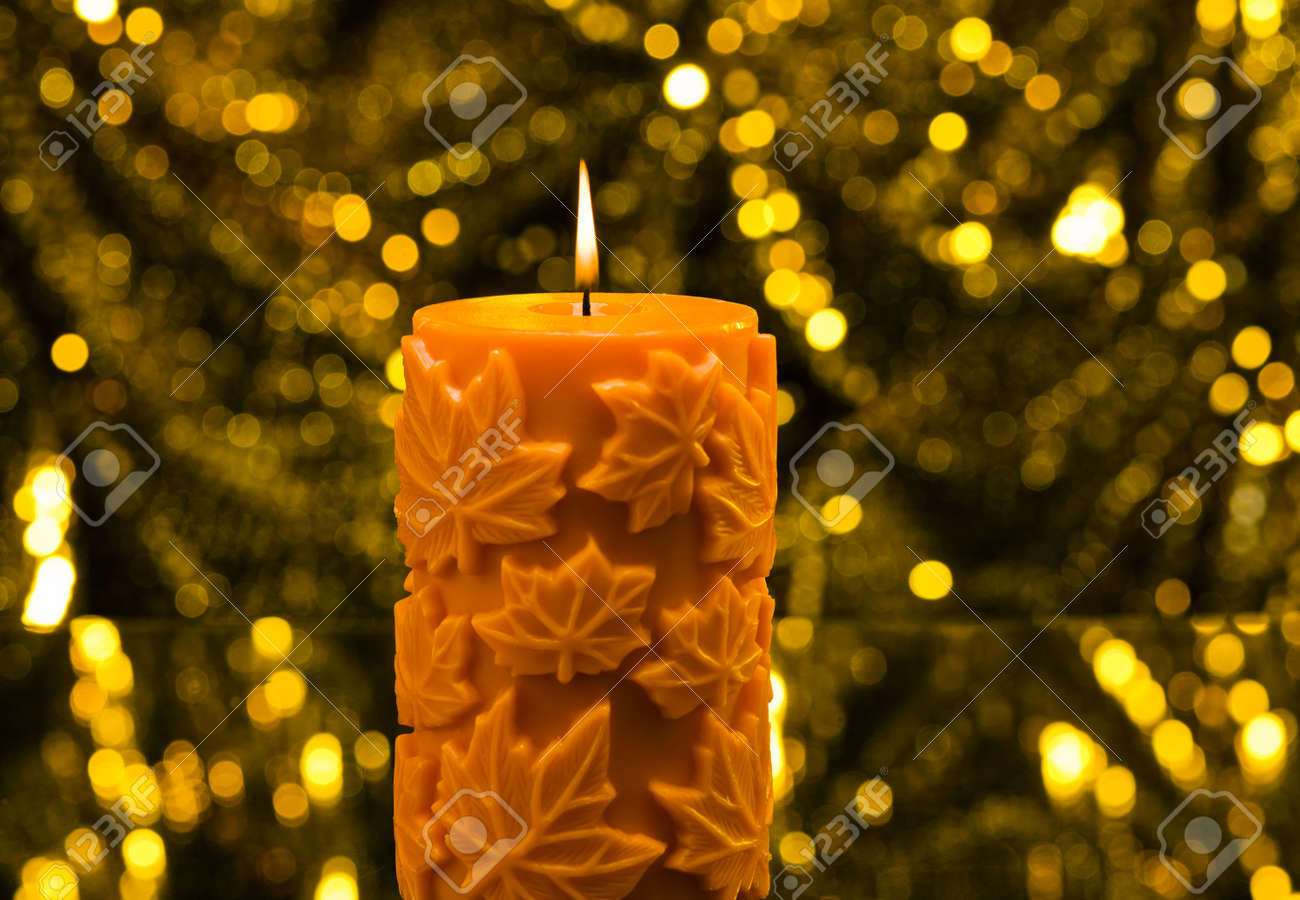 Orange Candle In Autumn Christmas Setting In Front Of A Golden Stock Photo Picture And Royalty Free Image Image 43158106