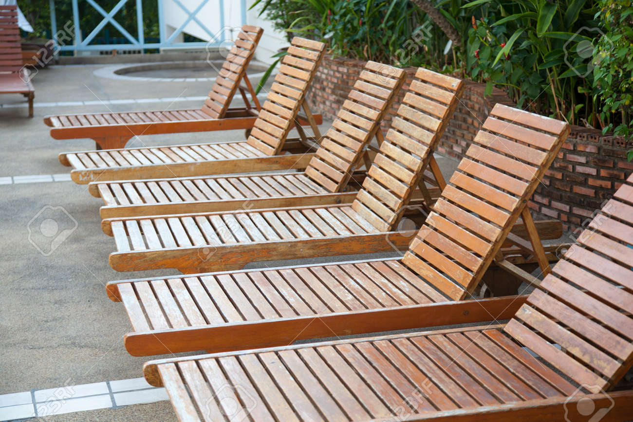 Pool Beds wooden bed beside the pool. the beds are arranged behind the Pool Beds wooden bed beside the pool. the beds are arranged behind the