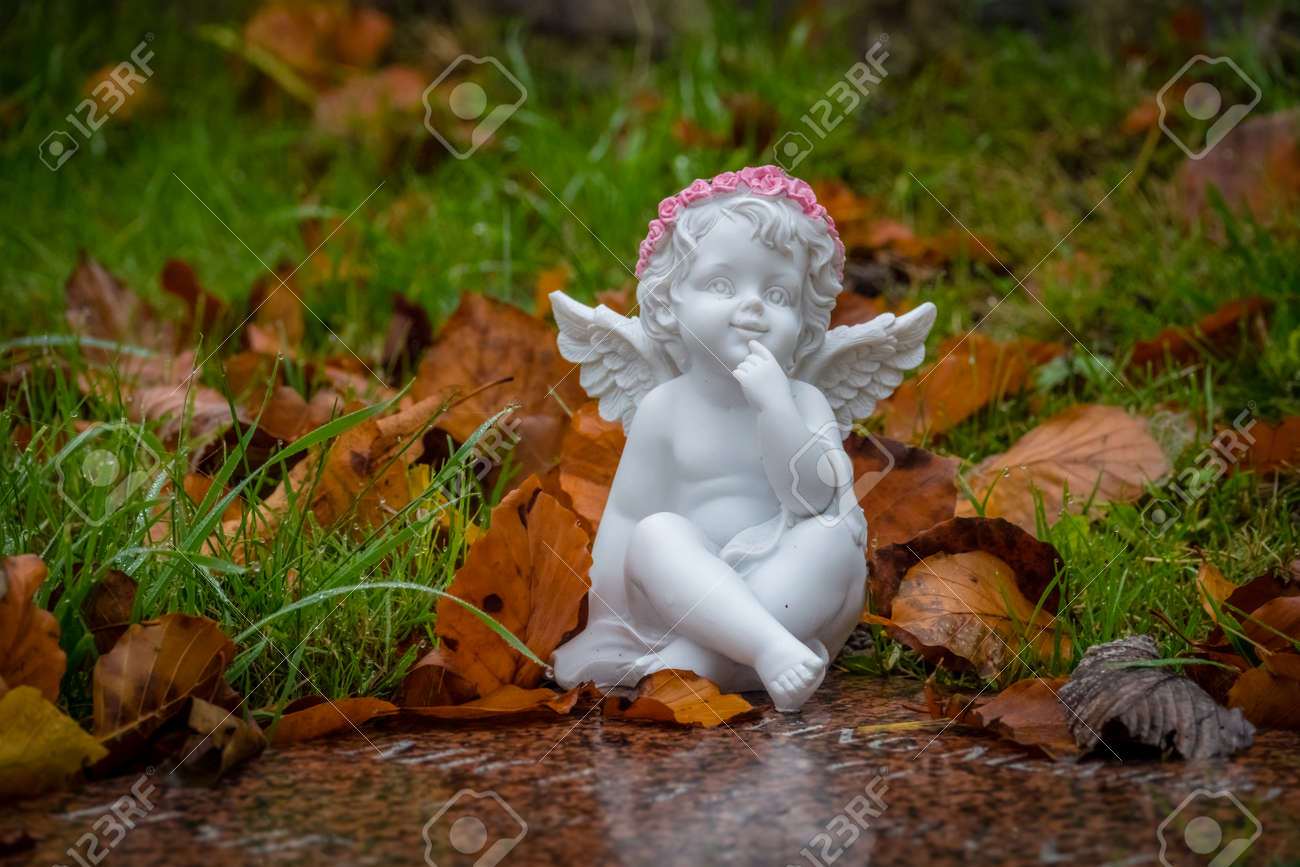Tiny Angel Figure Next To A Child Grave In Cemetery Stock Photo, Picture  and Royalty Free Image. Image 78819799.