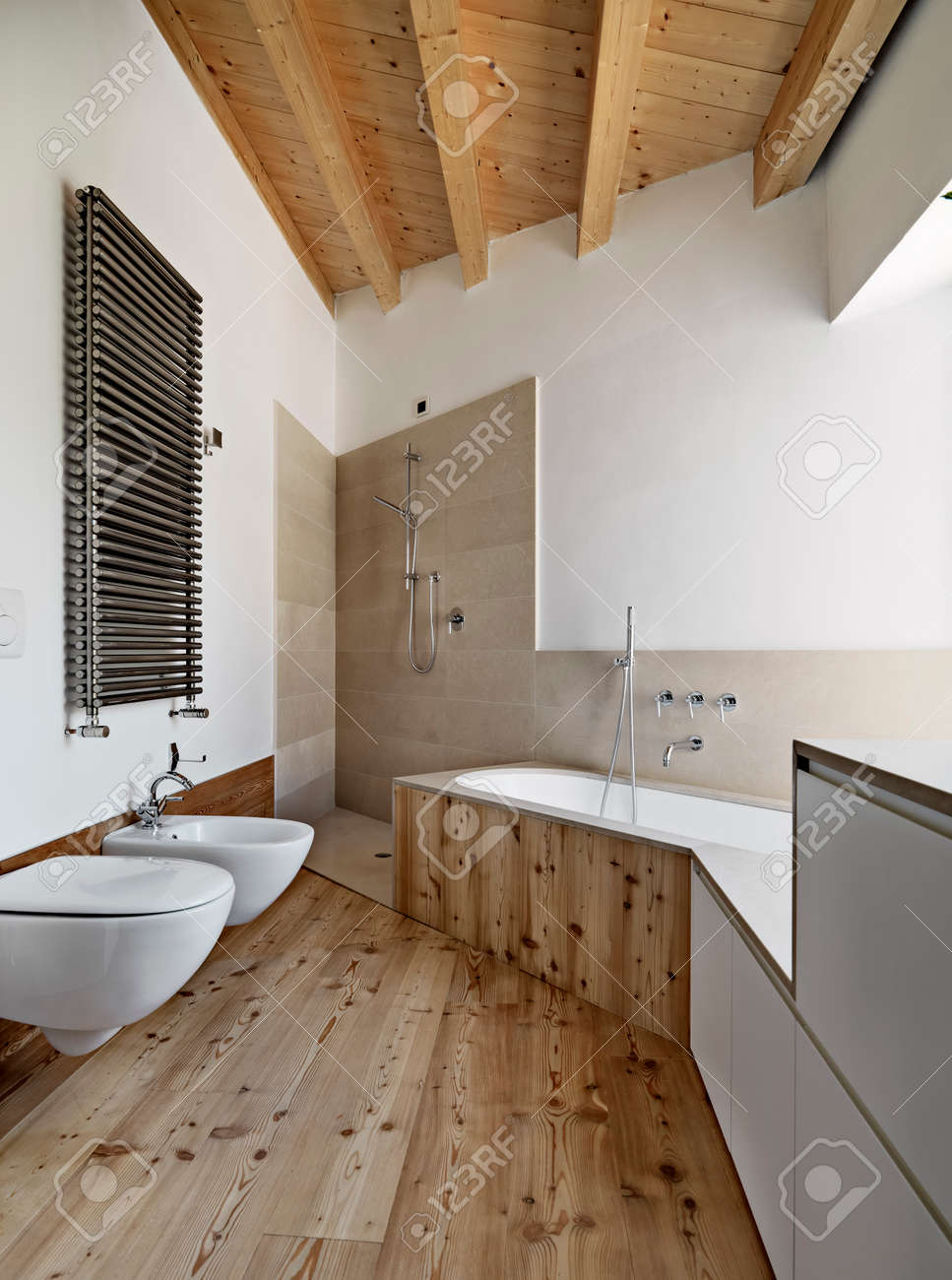 Interior View Of A Modern Bathroom With Wood Ceiling And Wood Floor Stock Photo