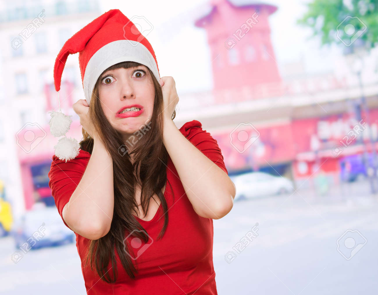 scared woman wearing a christmas hat, outdoor - 16290883 scared woman wearing a christmas hat, outdoor - 16290883