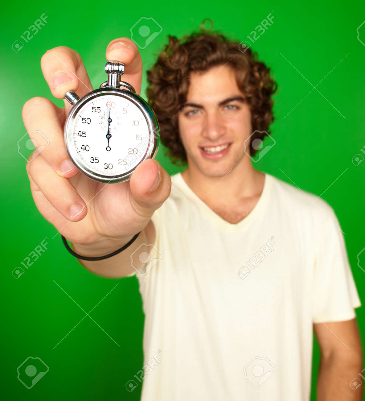 Man Holding Stopwatch On Green Background - 16671743 Man Holding Stopwatch On Green Background - 16671743