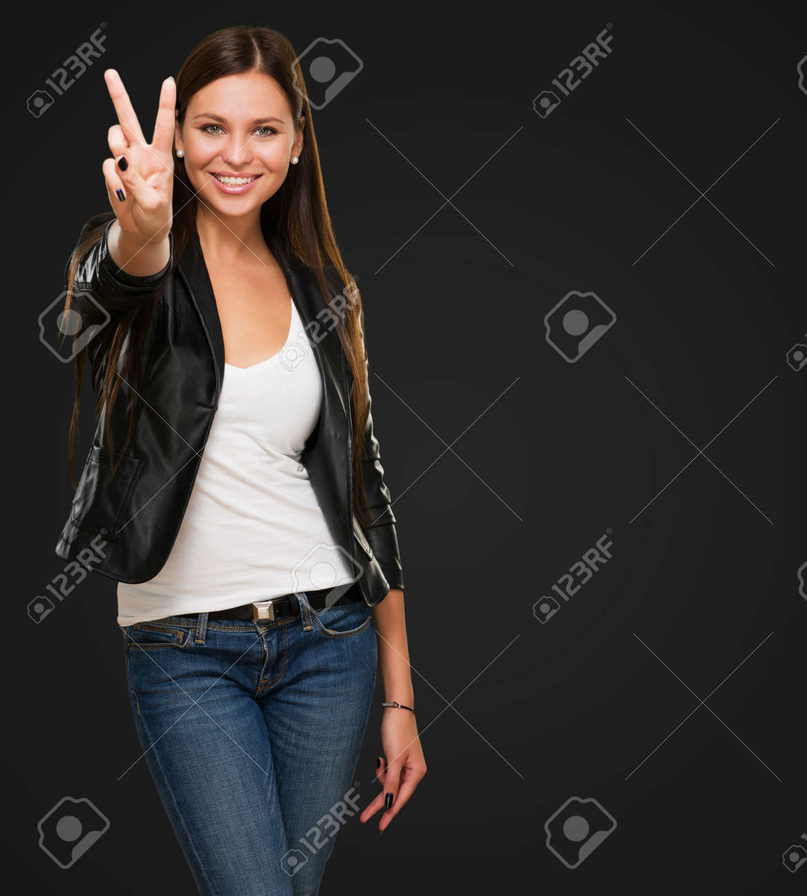 Beautiful Woman Giving Victory Sign against a black background - 16672549 Beautiful Woman Giving Victory Sign against a black background - 16672549