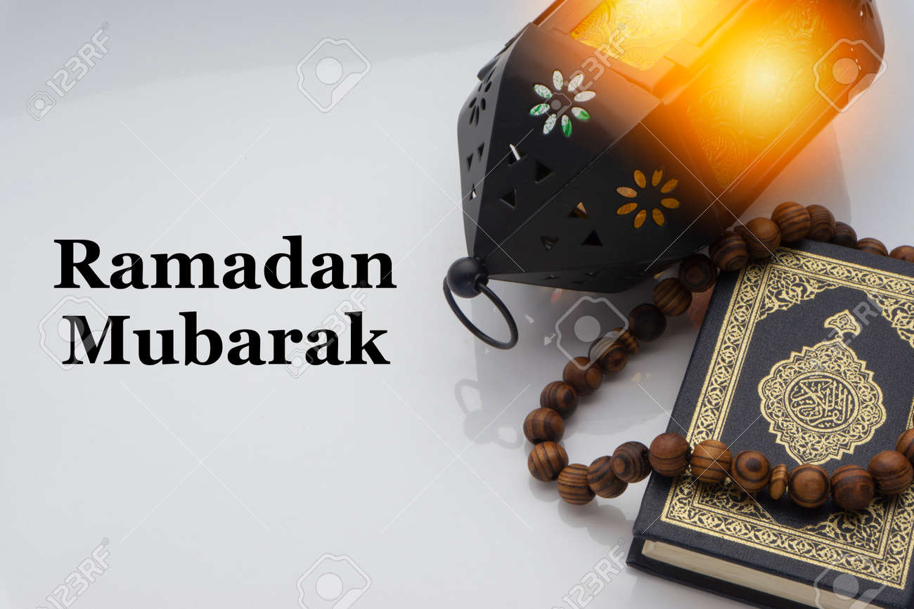 Ramadan Mubarak Text With Holy Al Quran With Written Arabic Calligraphy Meaning Of Al Quran And Rosary Beads Or Tasbih On White Background Stock Photo Picture And Royalty Free Image Image 147255155