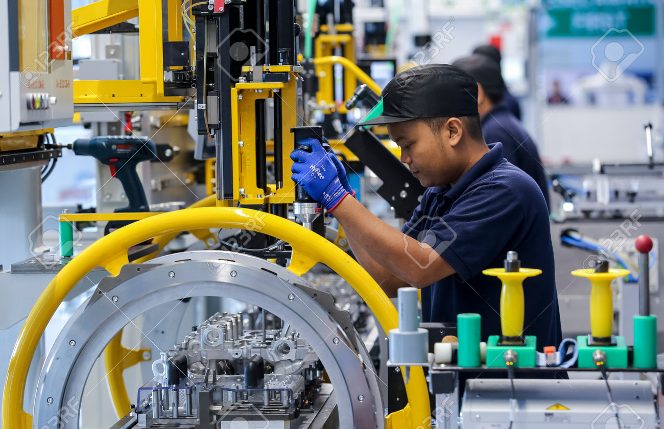 KEDAH, MALAYSIA - JULY 04, 2019 : Workers at engine assembly plant. Catering for both the domestic and export markets. Automotive & technology. - 130001621 KEDAH, MALAYSIA - JULY 04, 2019 : Workers at engine assembly plant. Catering for both the domestic and export markets. Automotive & technology. - 130001621