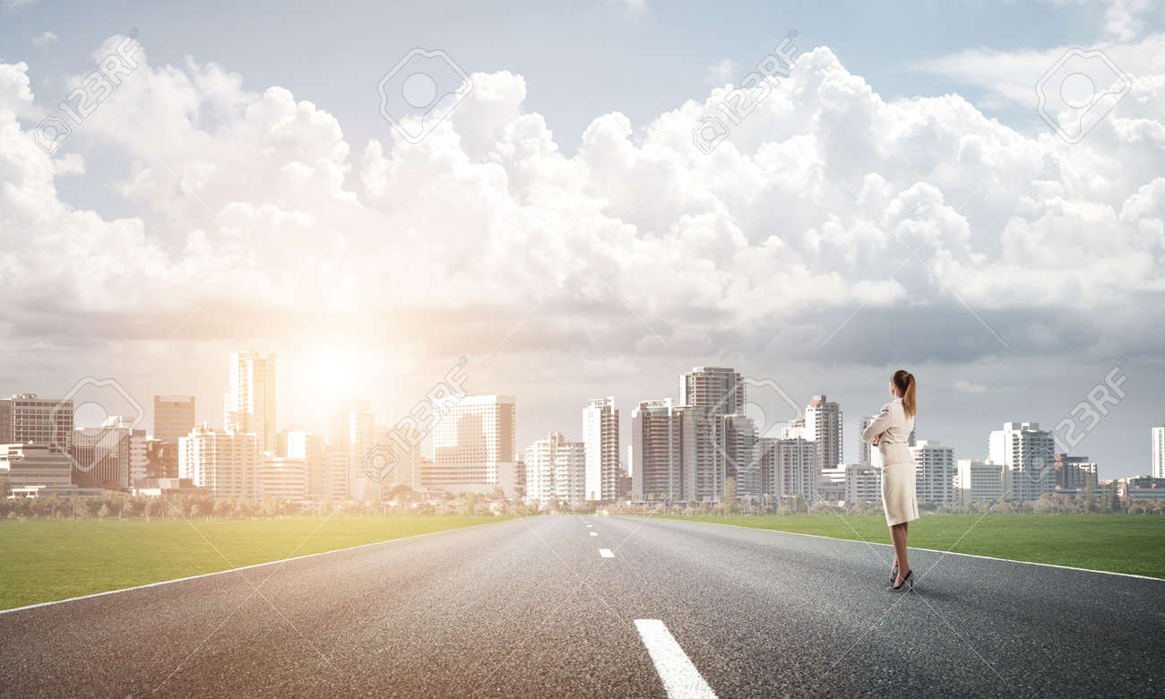 Elegant Businesswoman On Road Standing With Back And Looking Ahead Stock  Photo, Picture And Royalty Free Image. Image 64822643.
