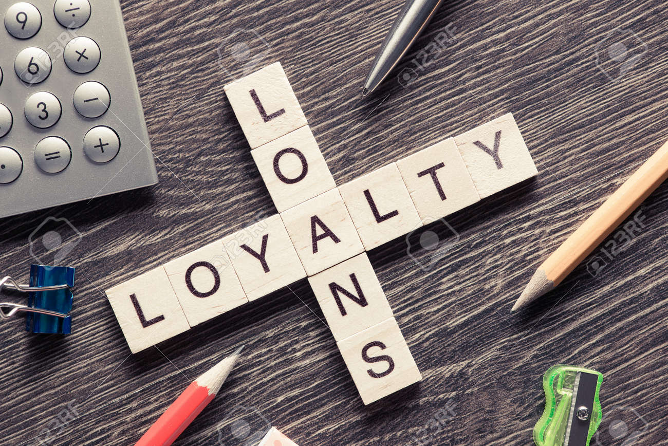 business workplace with loyalty loans words on table stock photo loans table