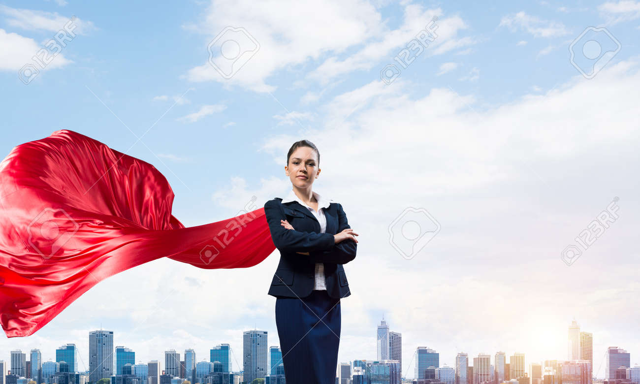 Young confident businesswoman wearing red cape against modern city background - 120172723 Young confident businesswoman wearing red cape against modern city background - 120172723