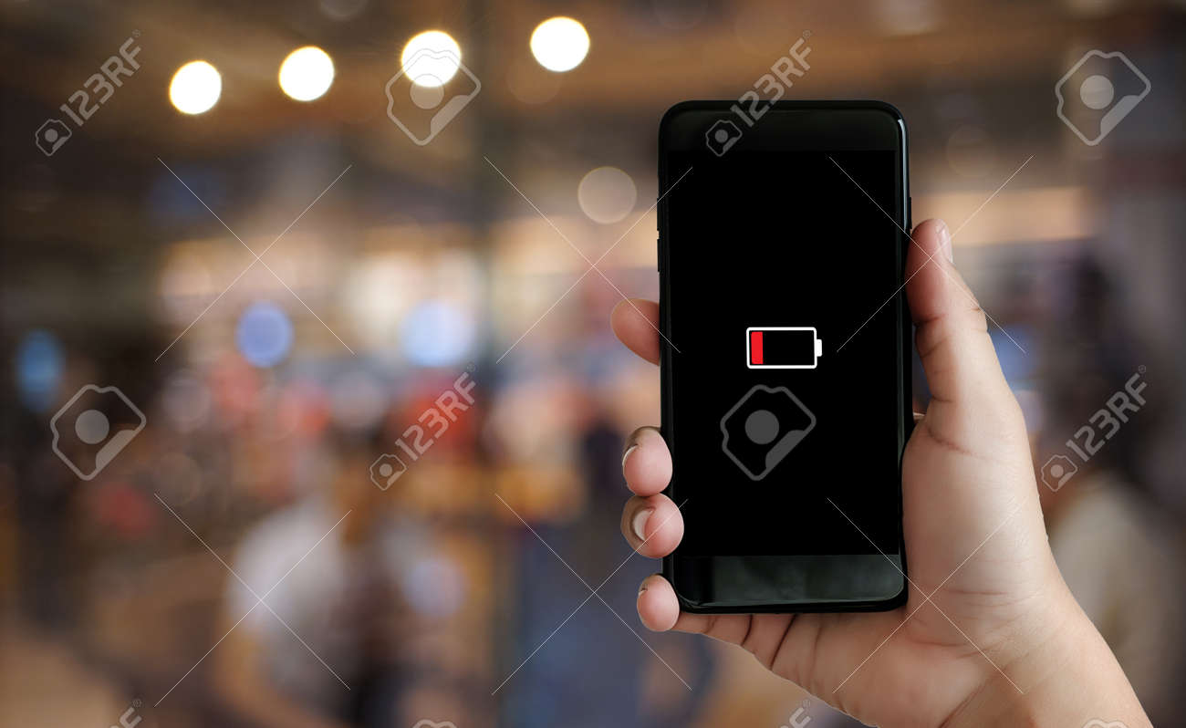 Close up man hands using smart phone battery low charged battery screen - 99702448 Close up man hands using smart phone battery low charged battery screen - 99702448