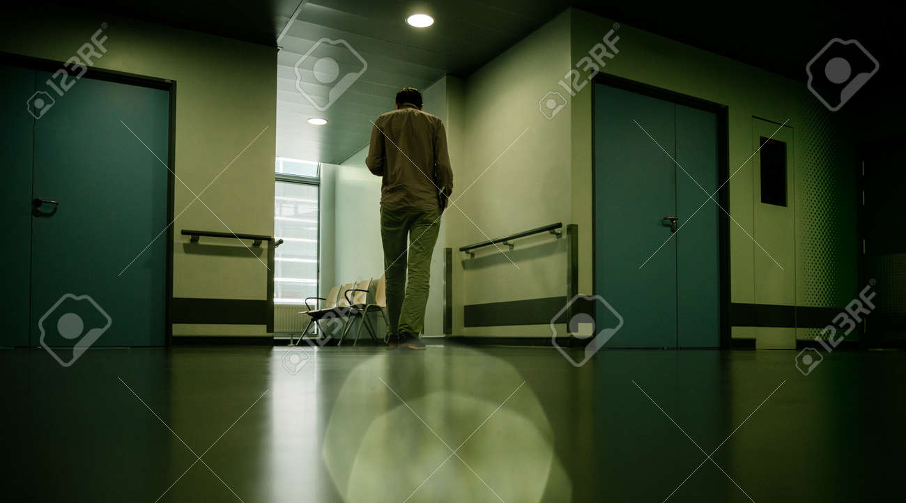 Low Angle View Of Lonely Patient In Full Length In Modern Hospital
