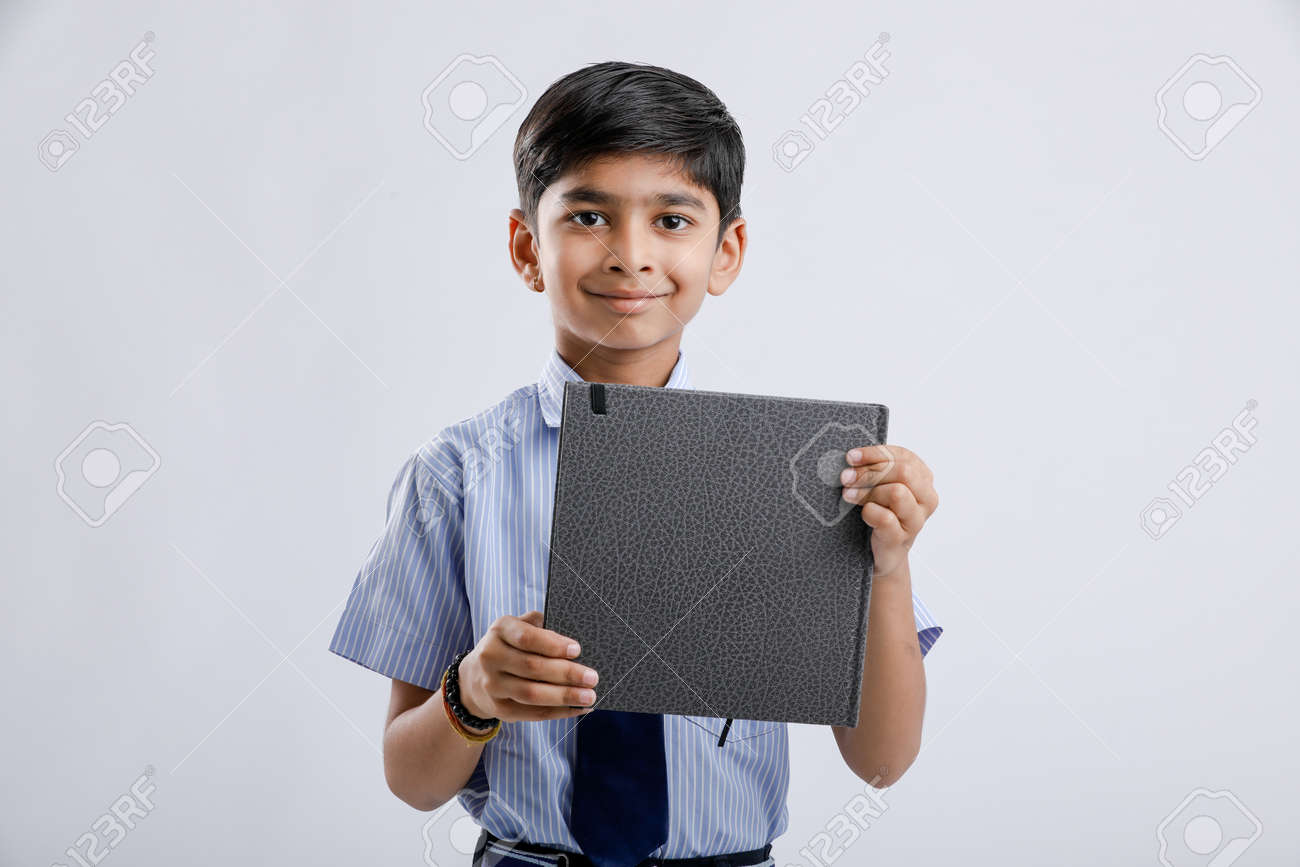 Cute Little Indian/Asian School Boy Showing Note Book Over White Background  Stock Photo, Picture and Royalty Free Image. Image 124419355., image size:1300x867