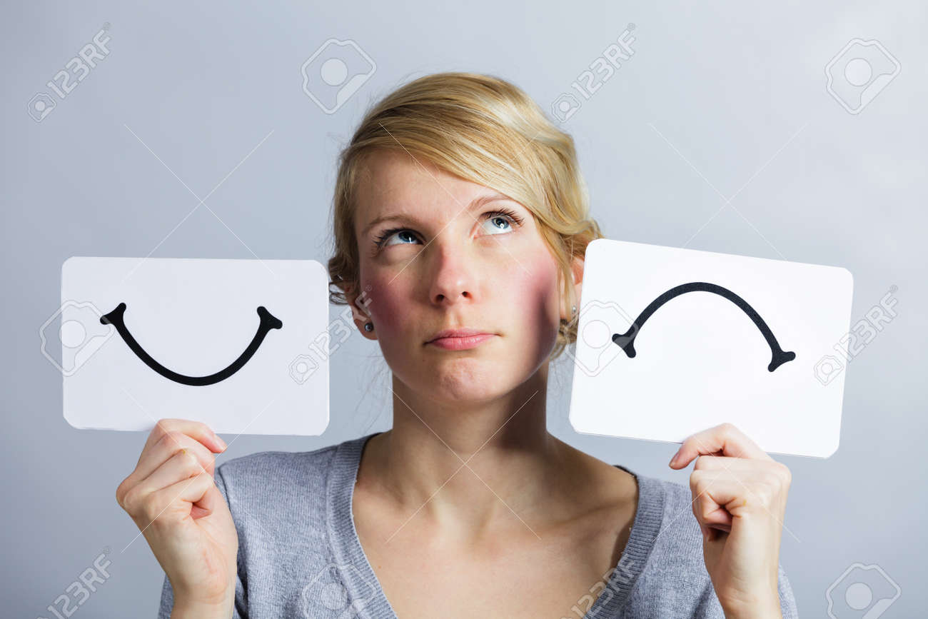 Portrait of a Questioning Woman Holding Happy and Unhappy Survey Mood Board - 38429314 Portrait of a Questioning Woman Holding Happy and Unhappy Survey Mood Board - 38429314
