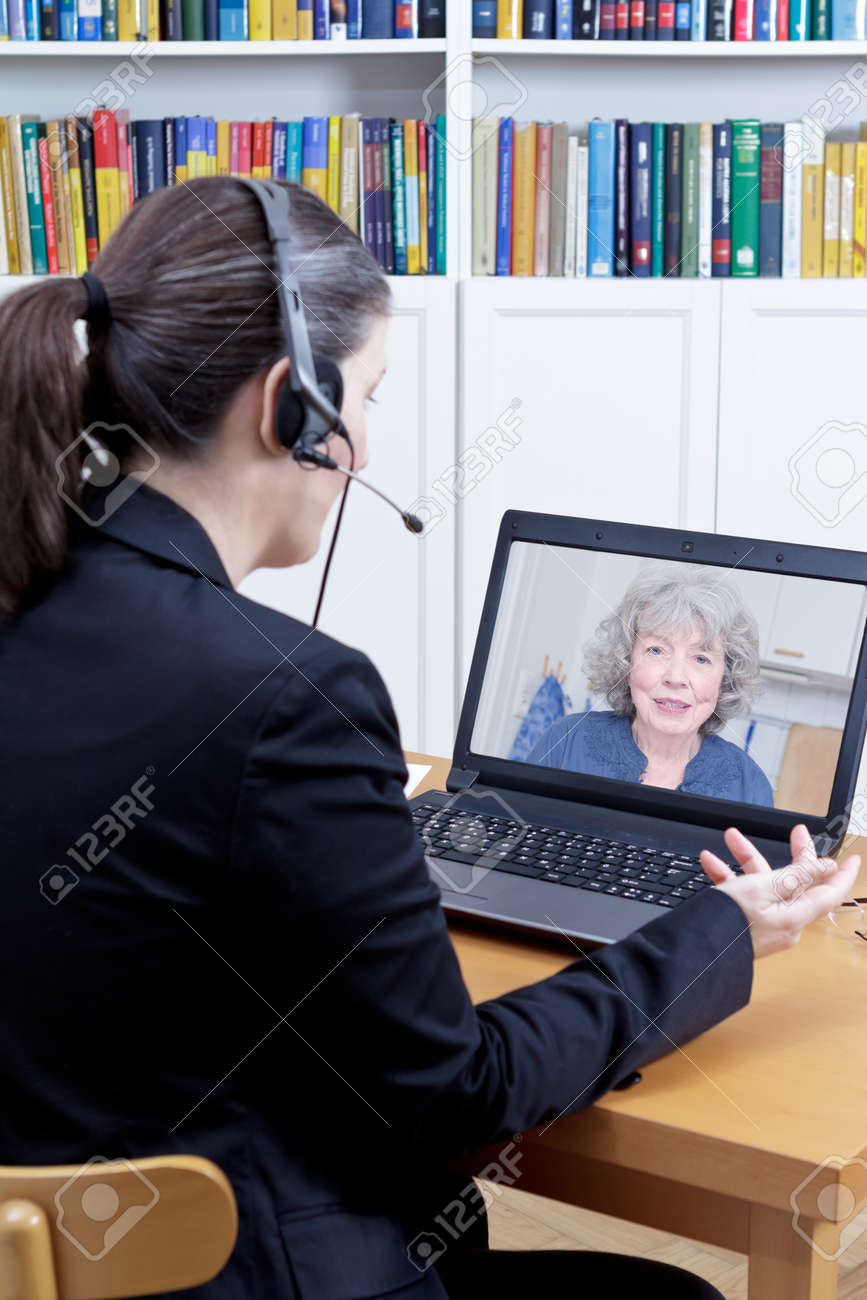 Female psychologist with headset in her office in front of her computer, talking to a senior woman during a live video call or chat, online counseling session template - 83563467 Female psychologist with headset in her office in front of her computer, talking to a senior woman during a live video call or chat, online counseling session template - 83563467