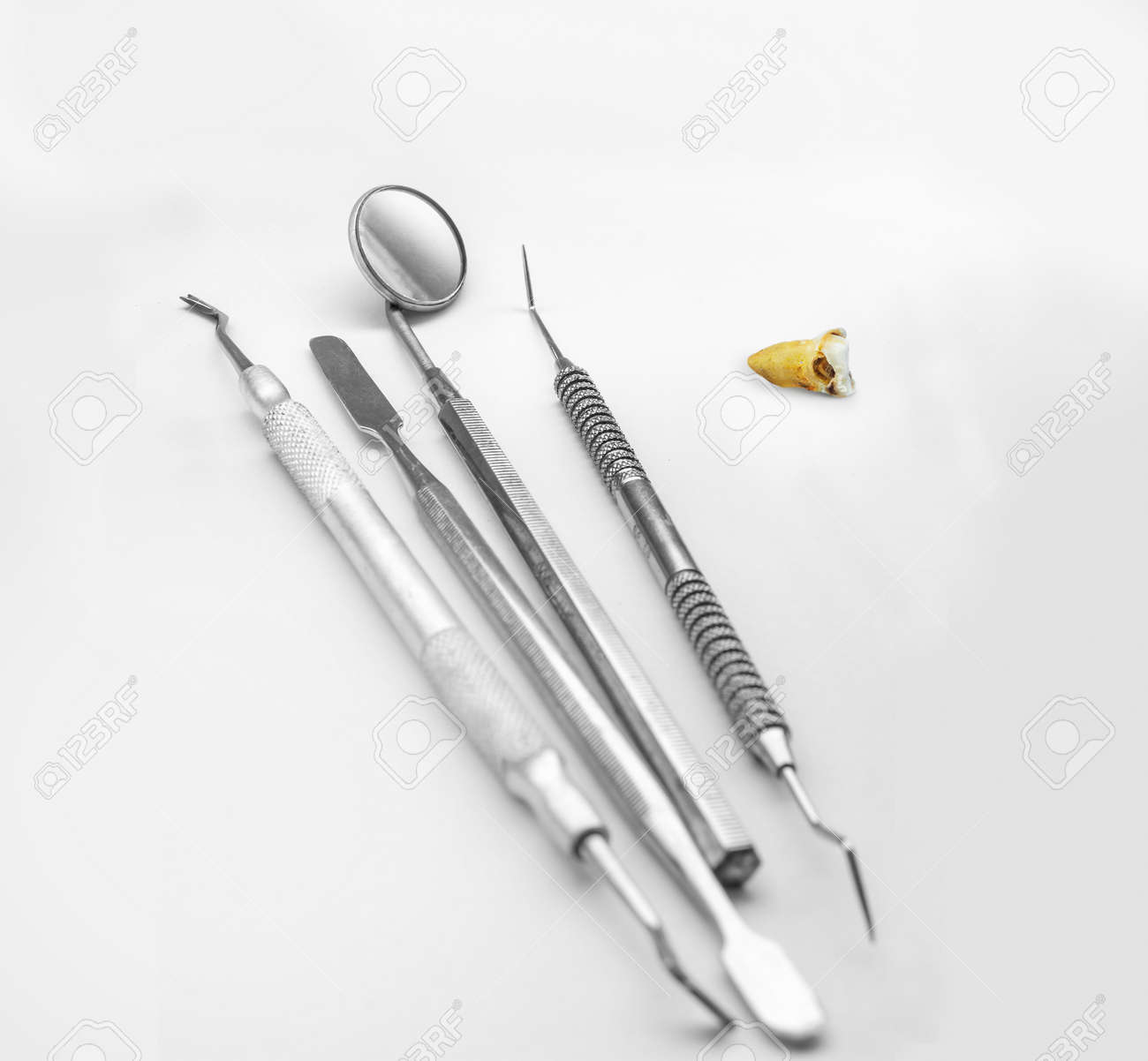 dentist s tools and wisdom tooth with with a big caries hole stock