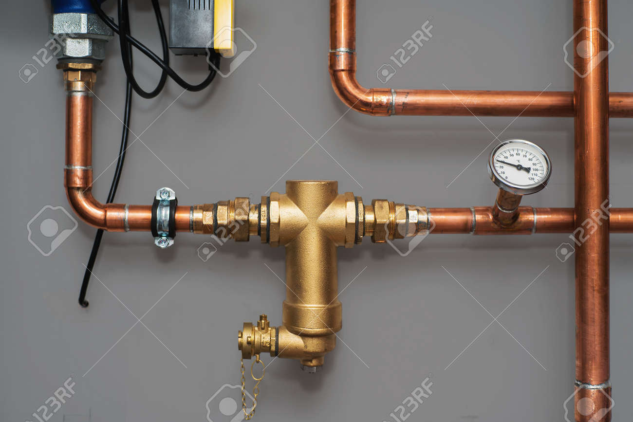 Thermometer and water filter for central heating system on a grey wall in a boiler room. Close up. - 93295413 Thermometer and water filter for central heating system on a grey wall in a boiler room. Close up. - 93295413
