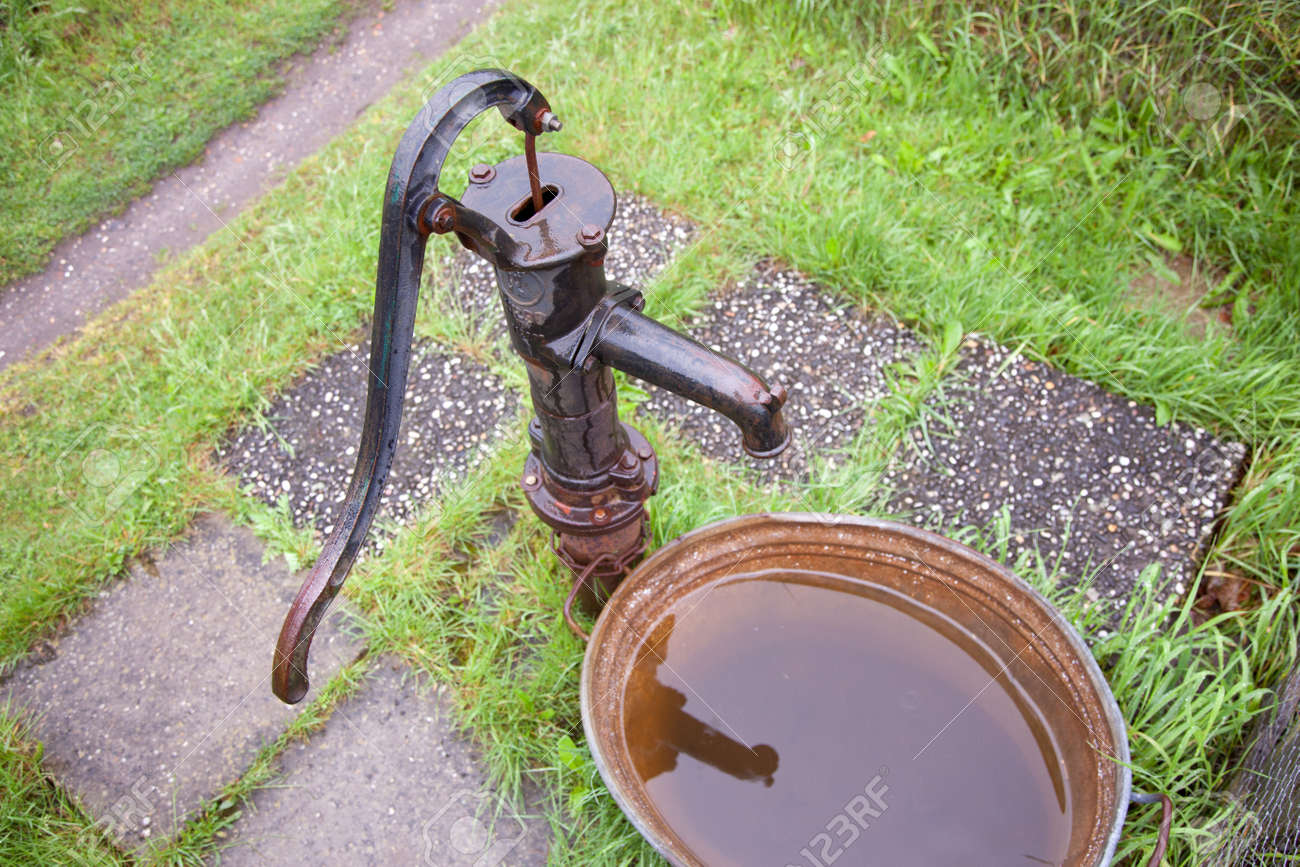 Fonte Ancienne Pompe à Eau De Fer Humide Dans Le Jardin