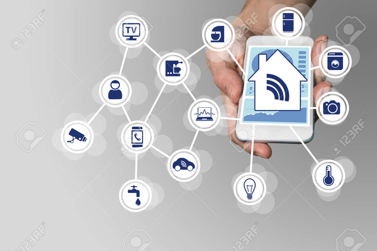 Hand holding modern smart phone on neutral background. Smart home automation concept with connected devices - 53754039 Hand holding modern smart phone on neutral background. Smart home automation concept with connected devices - 53754039