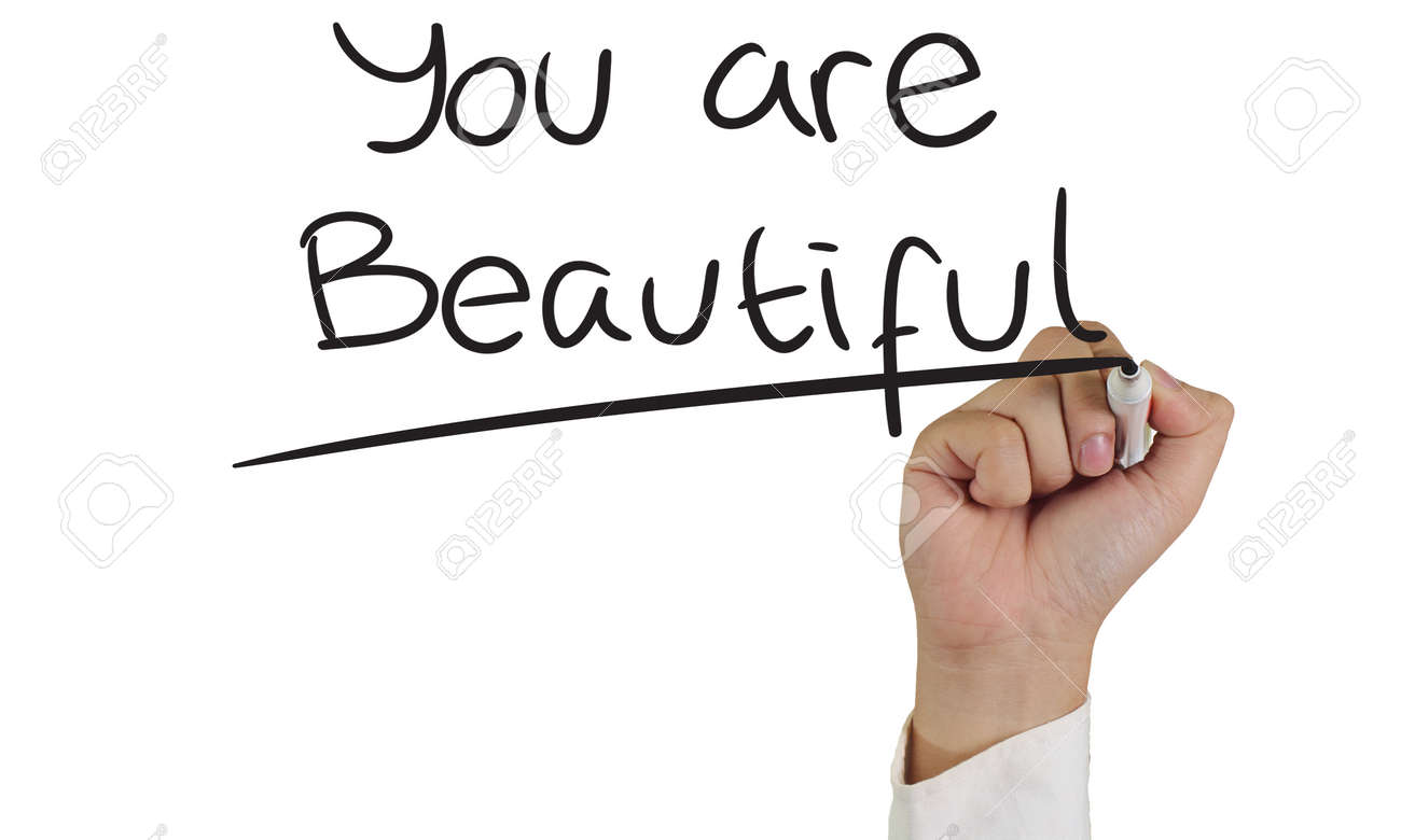 Image Of A Hand Holding Marker And Write You Are Beautiful Words