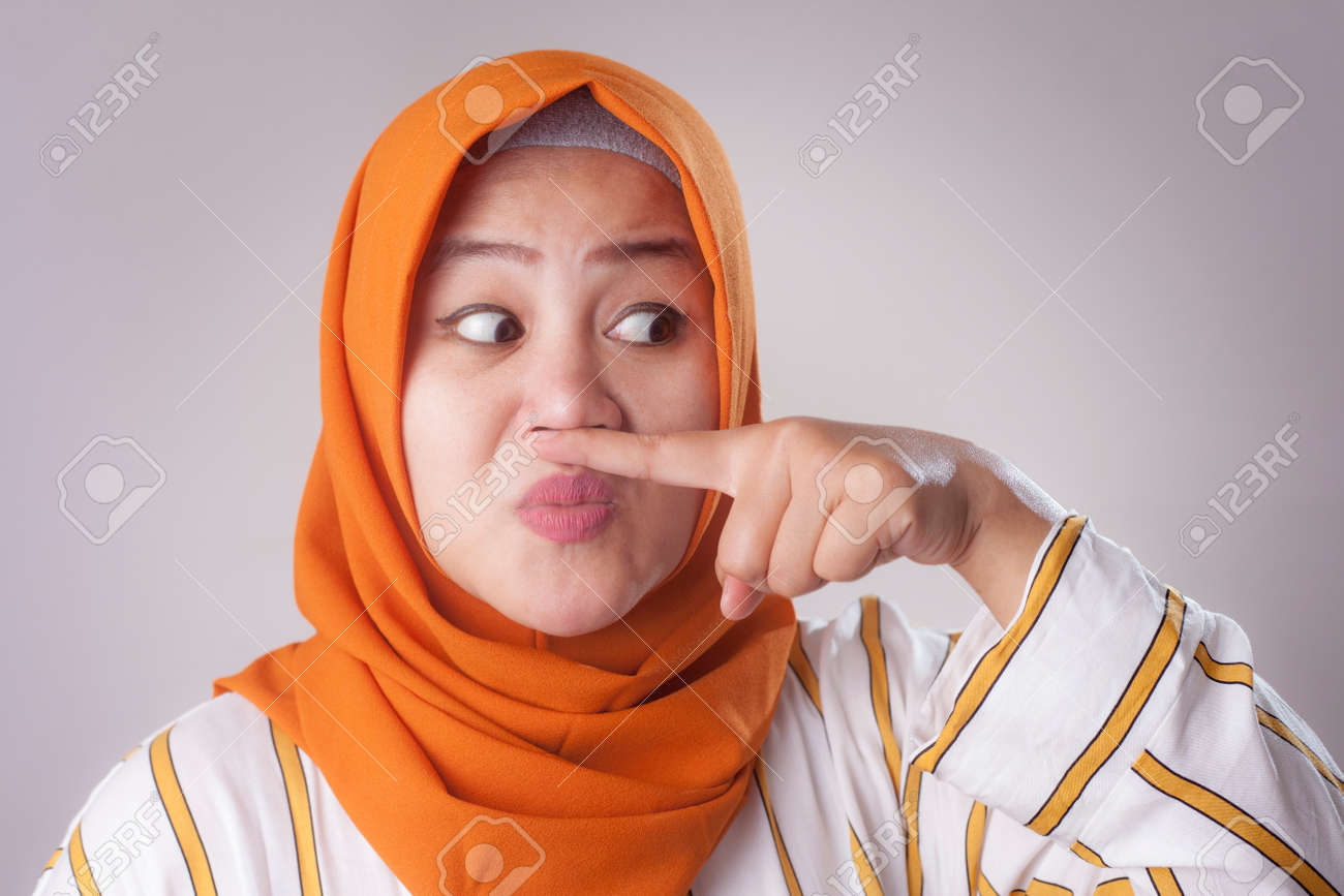 Portrait Of Cute Funny Asian Muslim Lady Wearing Hijab Close Her Nose Because Of Bad Disgusting Smell Odor Stock Photo, Picture And Royalty Free Image. Image 117168366. Portrait Of Cute Funny Asian Muslim Lady Wearing Hijab Close Her Nose Because Of Bad Disgusting Smell Odor Stock Photo, Picture And Royalty Free Image. Image 117168366.