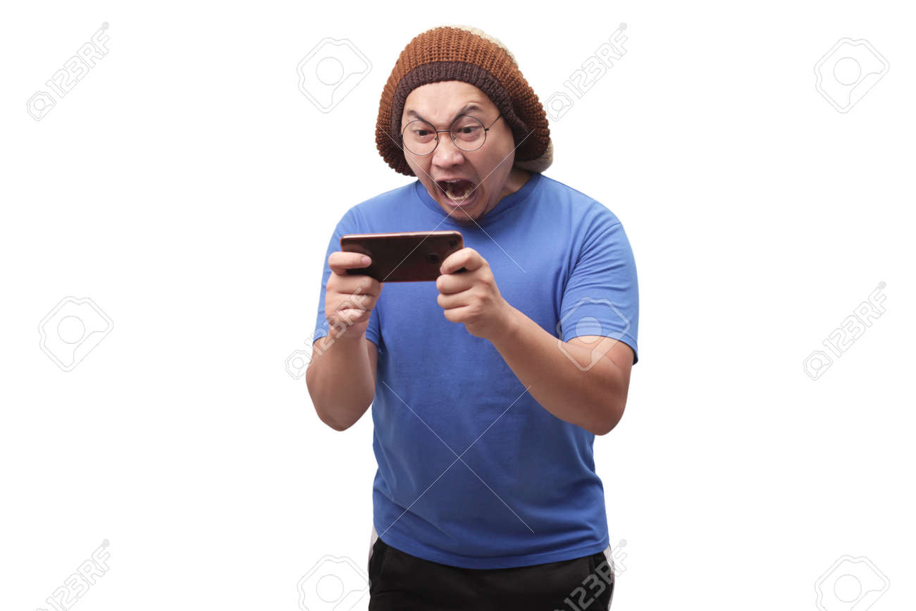 Portrait Of A Cute Handsome Young Asian Man With Funny Face Playing Games  On Tablet, Sad Angry Loosing Expression Stock Photo, Picture And Royalty  Free Image. Image 130471210.