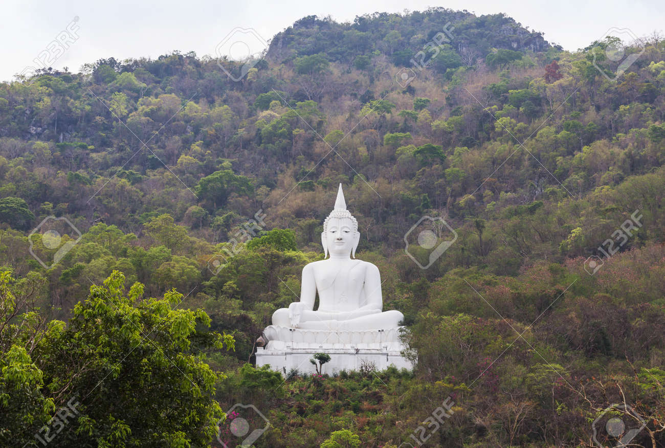 big white buddha statue sitting on the mountain at pakchong stock